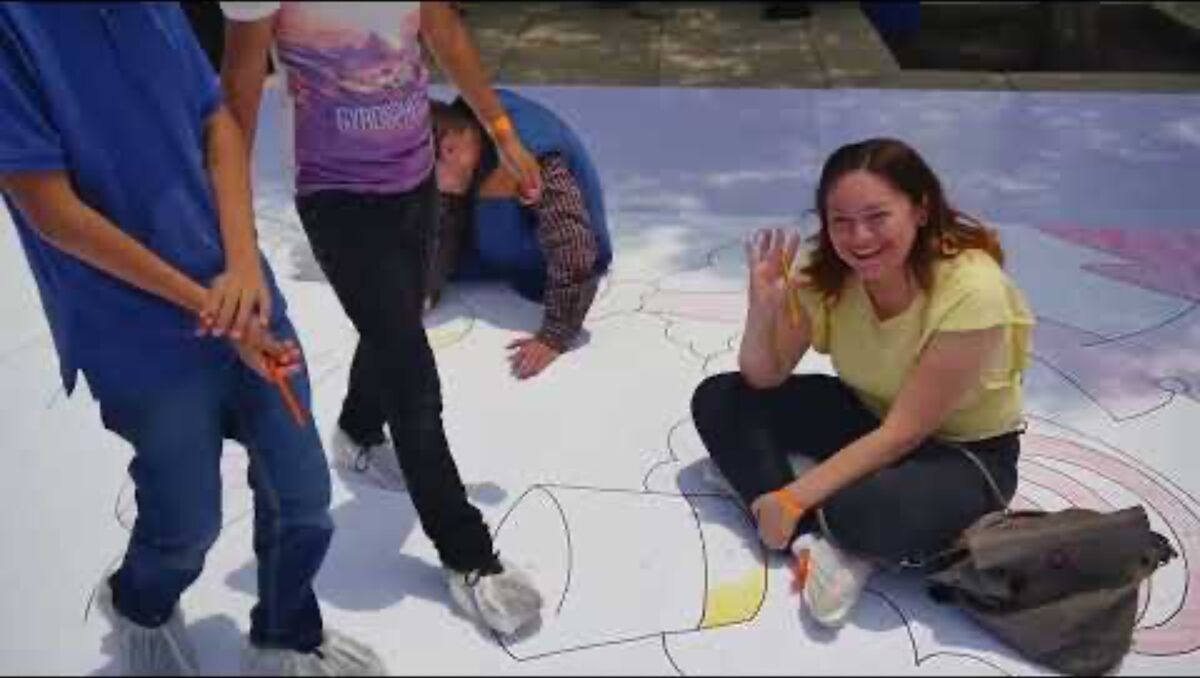 Participants coloring the world's largest drawing on site