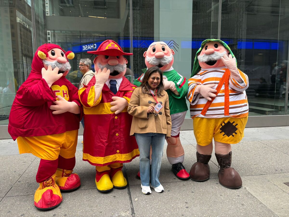 Dr. Simi mascots and staff greeting people on the street