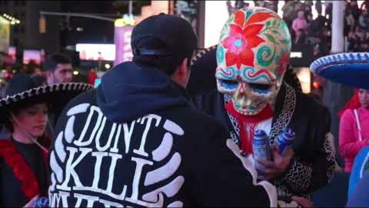 A catrina skull mask up close in Times Square
