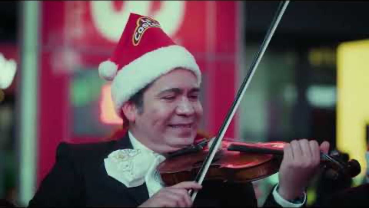 Mariachi violinist in a Santa hat playing in Times Square